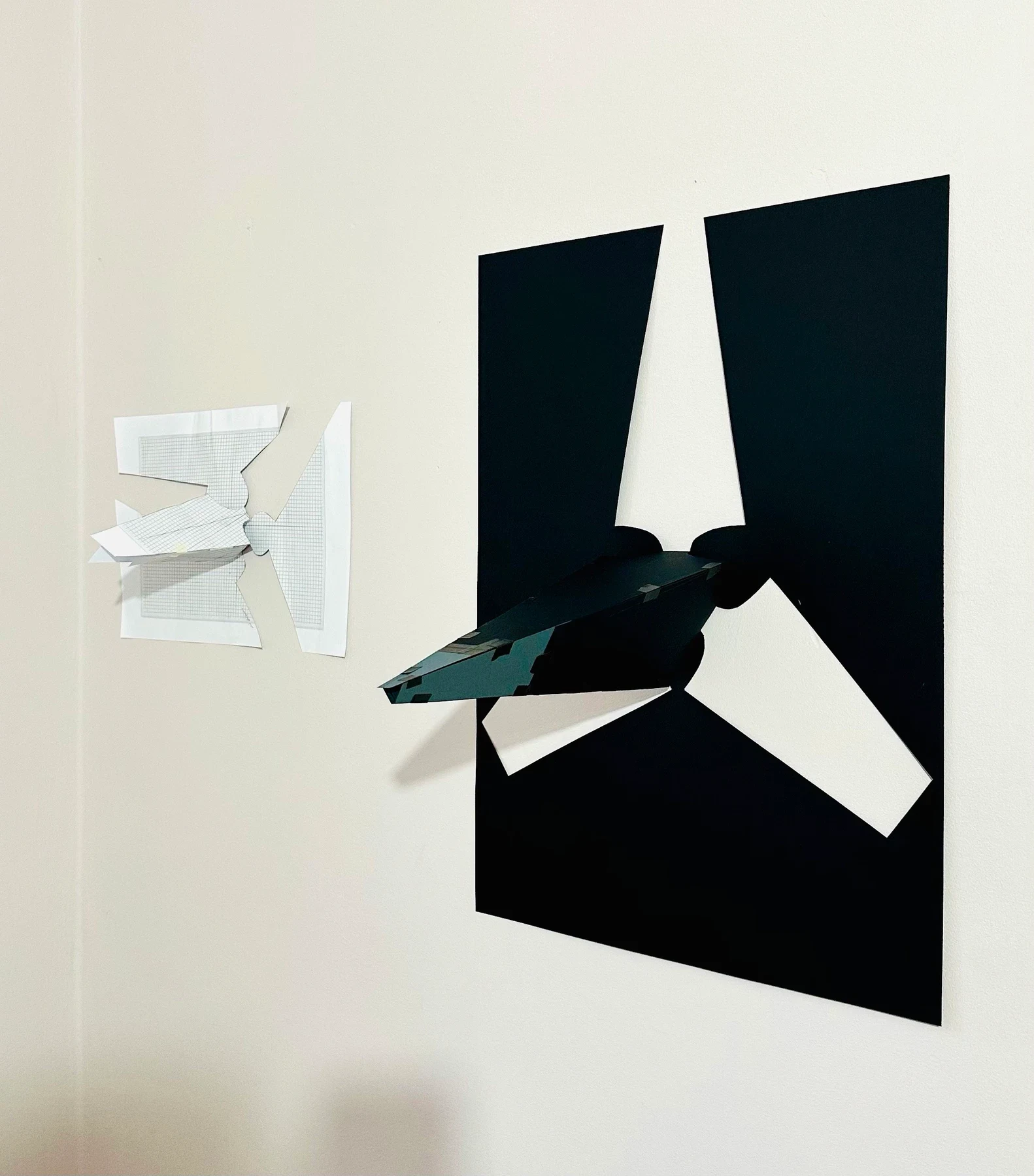 Detail of a black wall work with a projecting folded shape.
