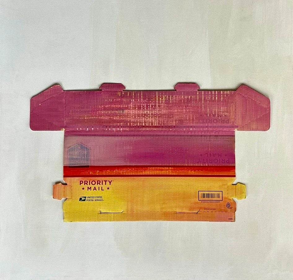 A red and yellow painted cardboard box opened flat.