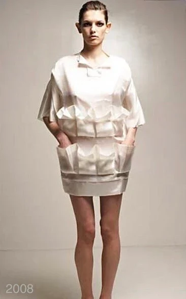 A person in a short padded cream dress.