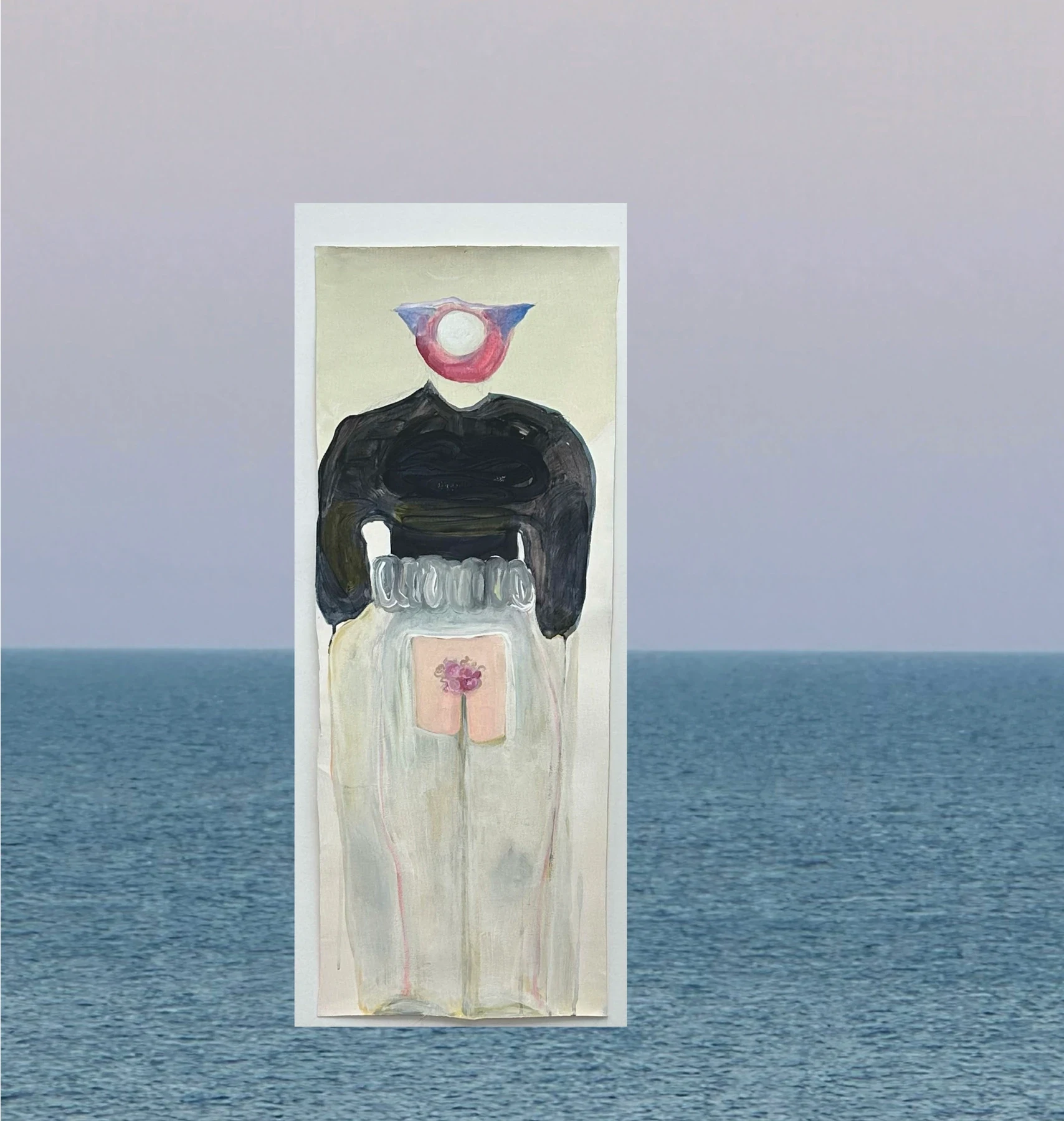 A small painted figure on a white panel against the sea.