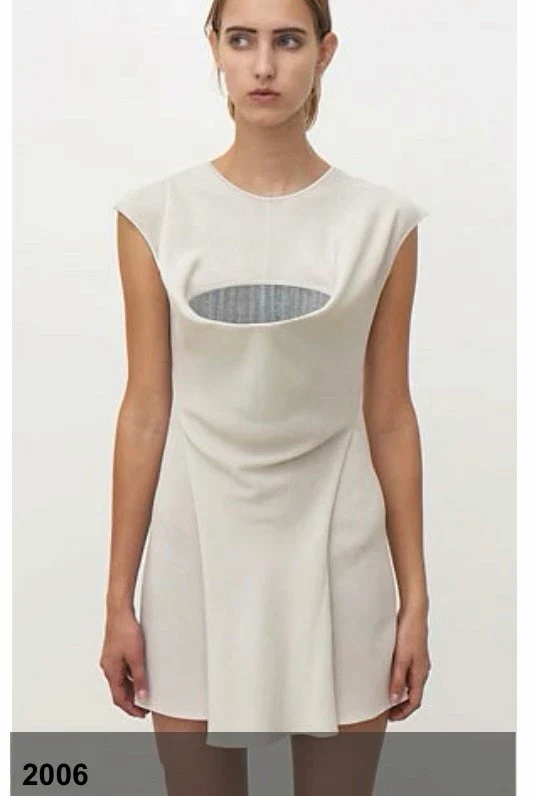 A person in a white sleeveless garment with an oval mesh opening.