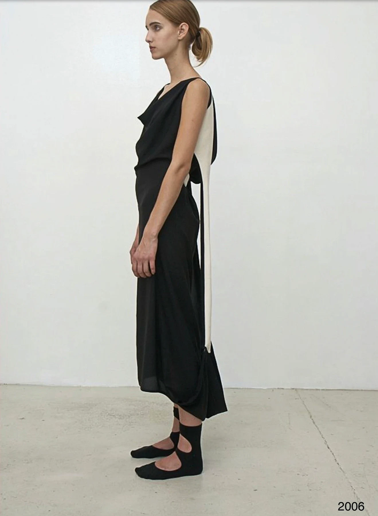 Side view of a person in a long black dress.