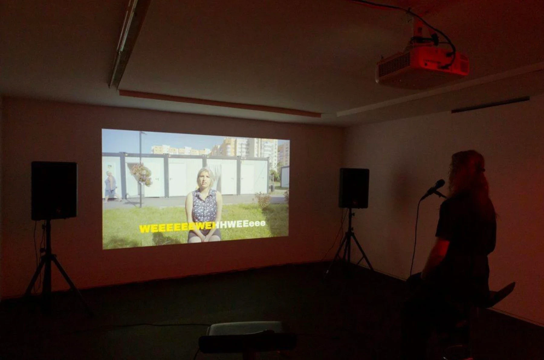 A video projection in a dark gallery room.