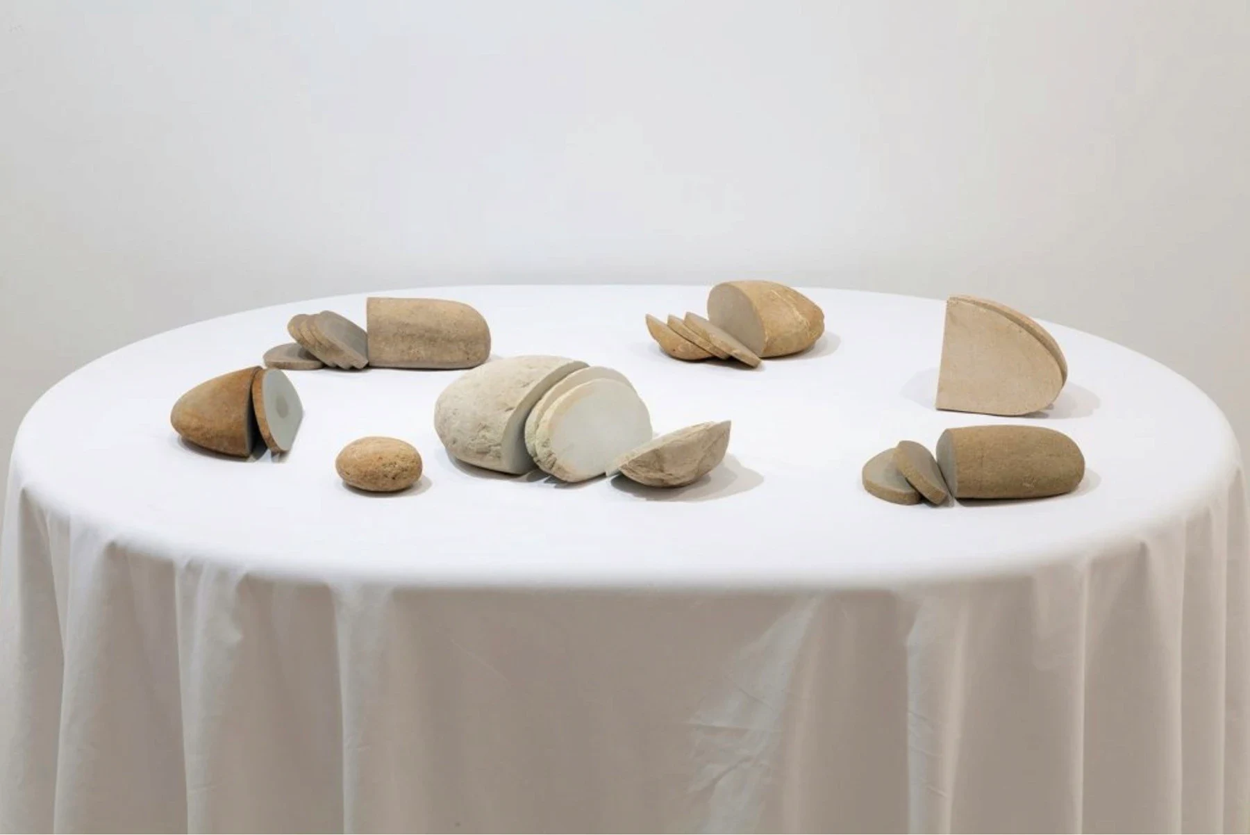 Small rounded objects arranged on a white circular table.