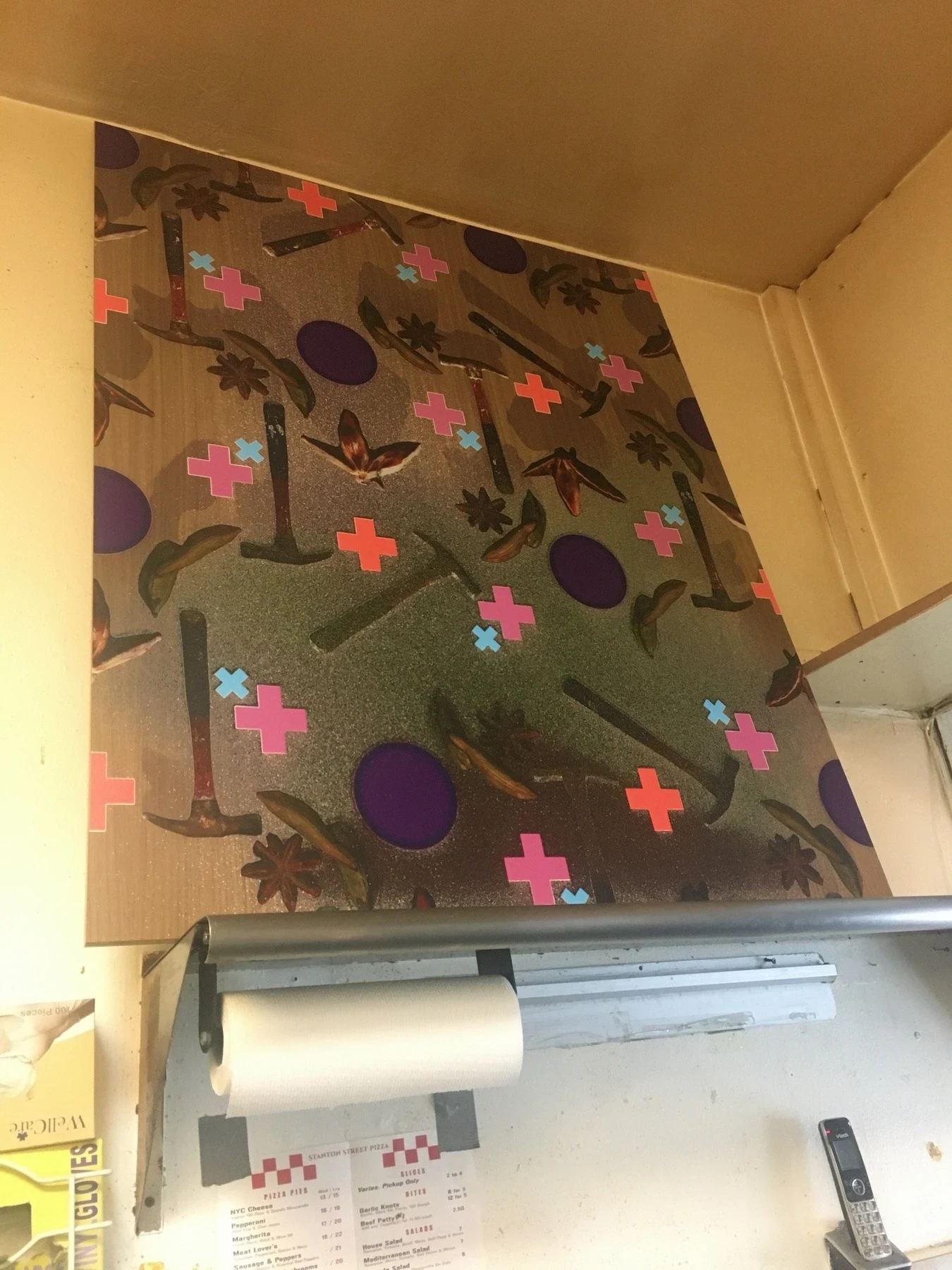A patterned textile suspended near the shop ceiling.